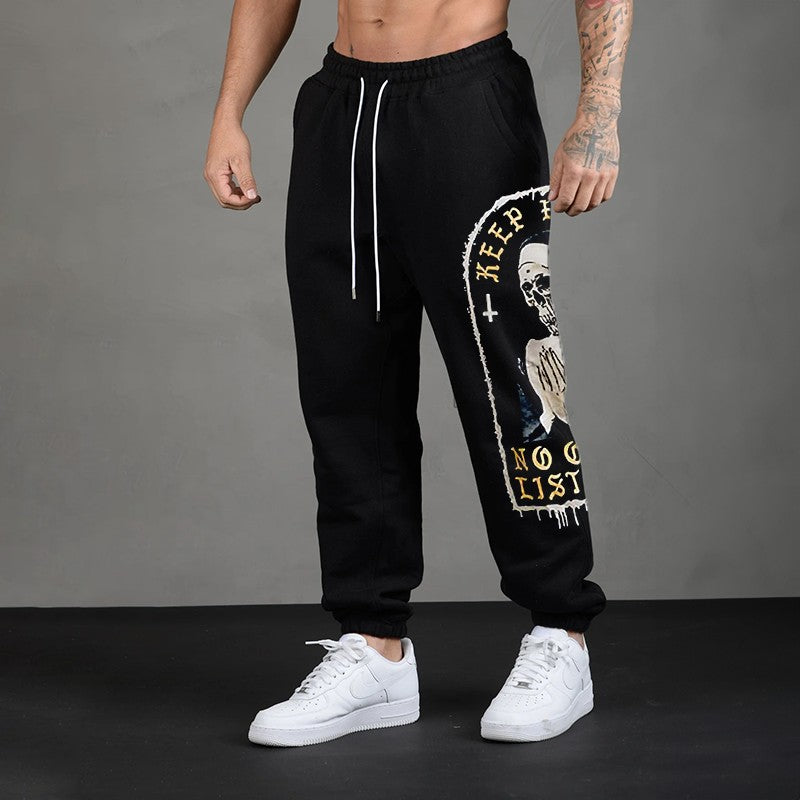 KEEP PRAYING NO ONE IS LISTENING Skull GRAPHIC PRINT JOGGERS