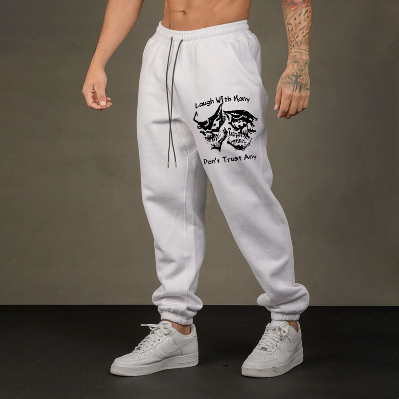 LAUGH WITH MANY, DON’T TRUST ANY SKULLS GRAPHIC PRINT JOGGERS