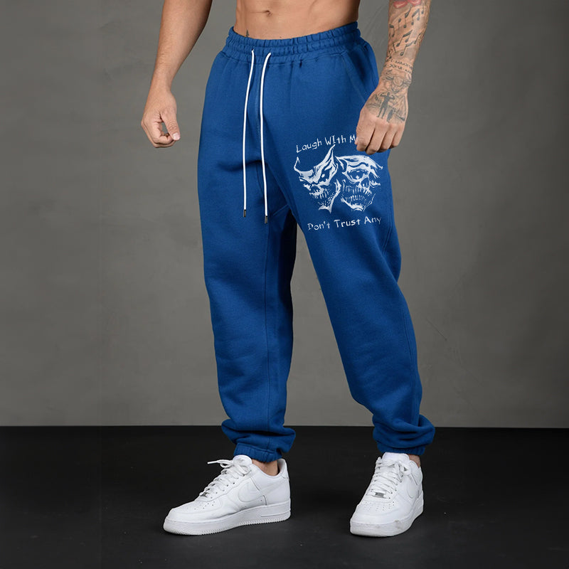 LAUGH WITH MANY, DON’T TRUST ANY SKULLS GRAPHIC PRINT JOGGERS